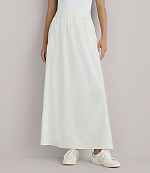 A person stands in a light green maxi skirt and white sneakers against a plain white background. carousel Product Image 2