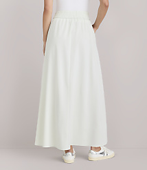 A person wearing a light green maxi skirt and sneakers stands against a plain white background. carousel Product Image 3