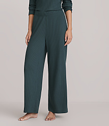 A person stands in dark green ribbed wide-leg pants against a plain white background. carousel Product Image 2