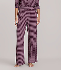 A person stands wearing burgundy and navy striped pajama pants and a matching top against a plain white background. carousel Product Image 2