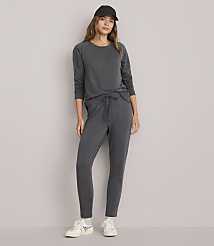 A woman in a dark gray loungewear set and a black baseball cap stands against a plain white background. carousel Product Image 1