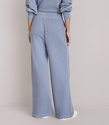 A person wearing light blue wide-leg sweatpants stands against a plain white background. carousel Product Image 3
