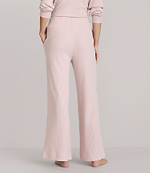 A person wearing pink waffle-knit pajama pants stands against a plain white background. carousel Product Image 3