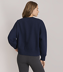 A woman in a navy sweatshirt and grey leggings stands against a plain white background. carousel Product Image 3