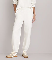 A person wearing cream-colored waffle-knit sweatpants and sneakers stands against a plain, light gray background. carousel Product Image 2