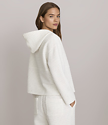 A woman in a white hooded jacket and pants stands against a plain gray background. carousel Product Image 3