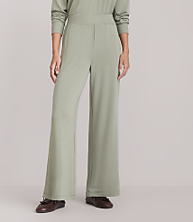 A person wearing light green wide-leg pants and brown loafers stands against a plain white background. carousel Product Image 2