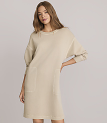 A woman in a beige sweatshirt dress with pockets stands against a plain gray background. carousel Product Image 2