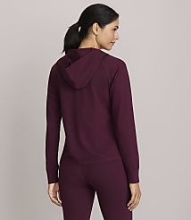 A woman in a burgundy hoodie and leggings stands facing away from the camera against a plain gray background. carousel Product Image 3