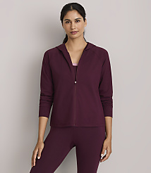 A woman in a burgundy hooded jacket and matching leggings stands against a plain gray background. carousel Product Image 2