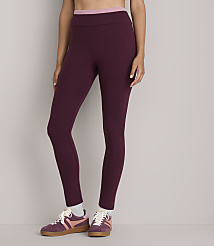 A person wearing burgundy leggings and pink and brown sneakers stands against a plain gray background. carousel Product Image 3