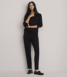 A woman in a black top and pants stands against a plain white background. carousel Product Image 1