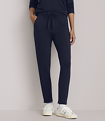A person in navy blue loungewear and white sneakers stands against a plain, light gray background. carousel Product Image 2