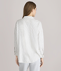 A woman wearing a checkered shirt and striped pants stands against a plain gray background. carousel Product Image 3