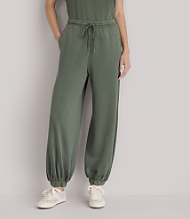 A person wearing olive green sweatpants and sneakers stands against a plain white background. carousel Product Image 2