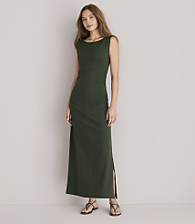 A woman in a dark green maxi dress stands against a plain white background. carousel Product Image 1