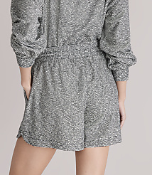 A person wearing a textured grey romper stands against a plain white background. carousel Product Image 3