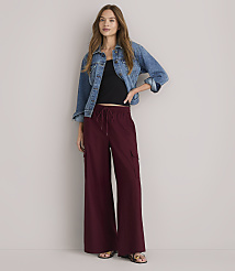 A woman in a denim jacket and maroon wide-leg pants stands against a plain white background. carousel Product Image 4