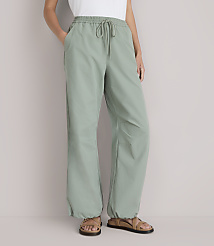 A person stands in light green pants with a drawstring waist and sandals, against a plain white background. carousel Product Image 2