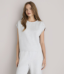 A young woman in a grey loungewear set and white sandals poses against a plain grey background. carousel Product Image 1