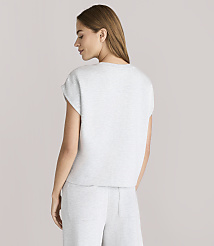 A woman in a light gray t-shirt and pants stands against a plain white background. carousel Product Image 3