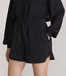 Black shorts with a drawstring waist are worn by a person against a plain white background. carousel Product Image 2