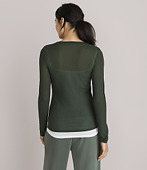 A woman in a sheer green long-sleeved shirt and white tank top stands against a plain, light gray background. carousel Product Image 3