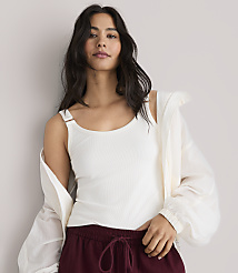 A woman in a white tank top and maroon pants stands against a plain white background. carousel Product Image 2