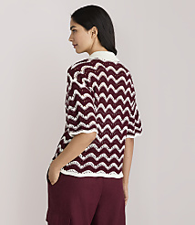 A woman in a burgundy and white chevron knit top and burgundy pants stands with her back to the viewer against a plain white background. carousel Product Image 3