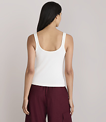 A woman in a white tank top and maroon pants stands against a plain white background. carousel Product Image 3