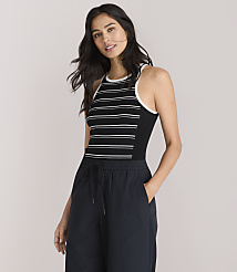 A woman in a striped tank top and dark pants stands against a plain white background. carousel Product Image 1