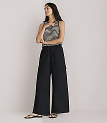 A woman in a striped tank top and black wide-leg pants stands against a plain white background. carousel Product Image 1