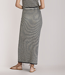 A person wearing a black and white striped maxi skirt and brown sandals stands against a plain white background. carousel Product Image 3