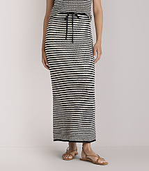 A person stands wearing a black and white striped maxi skirt and sandals against a plain white background. carousel Product Image 2