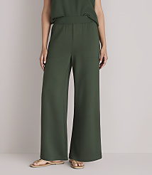 A person wearing dark green wide-leg pants and sandals stands against a plain white background. carousel Product Image 2