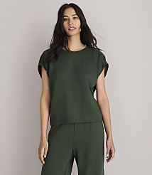 A woman in a dark green top and pants stands against a plain white background. carousel Product Image 1