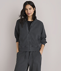 A woman in a dark grey waffle-knit jacket and pants poses against a plain white background. carousel Product Image 1