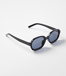 Black oval sunglasses rest on a plain white background. carousel Product Image 1