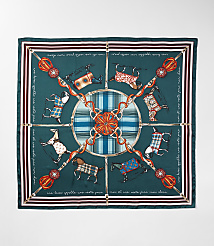 A square silk scarf with a dark teal background features a central circular design of plaid and ornate equestrian-themed elements, surrounded by a border of running horses in various patterned blankets and decorative tassels. carousel Product Image 2