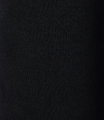 A black, textured fabric fills the frame, with subtle vertical ribbing visible in the foreground and a gradient of darkness towards the right background. carousel Product Image 2