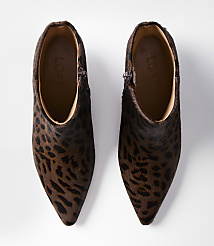 A pair of leopard-print ankle boots with pointed toes are laid out on a white background. carousel Product Image 3