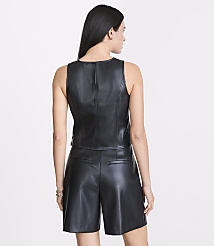 A woman in a black leather top and shorts stands against a plain white background. carousel Product Image 3