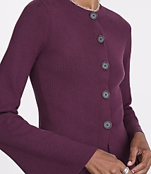 A close-up of a person wearing a plum-colored cardigan with dark buttons is set against a plain white background. carousel Product Image 4