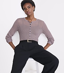 A woman in a sheer mauve top and black pants sits against a plain white background. carousel Product Image 2