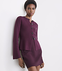 A woman in a burgundy cardigan and skirt stands against a plain white wall. carousel Product Image 2