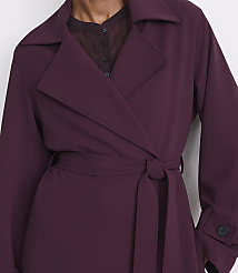A person in a deep plum trench coat with a tie belt stands against a plain white background. carousel Product Image 4