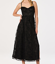 A woman in a black lace dress stands against a plain white background. carousel Product Image 4