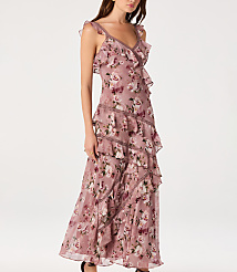 A woman in a ruffled, floral maxi dress stands against a plain white background. carousel Product Image 4