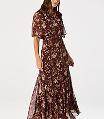 A woman in a floral dress stands against a plain white background. carousel Product Image 4