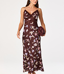 A woman in a floral slip dress and holding a clutch walks against a plain white background. carousel Product Image 4